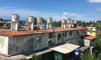 Habana rooftops with water tanks that have "Viva Cuba" painted on them