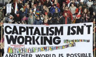 Protesters from Occupy Wall Street holding a banner that reads "capitalism isn't working."