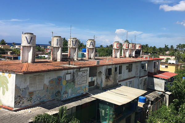 Habana rooftops with water tanks that have "Viva Cuba" painted on them