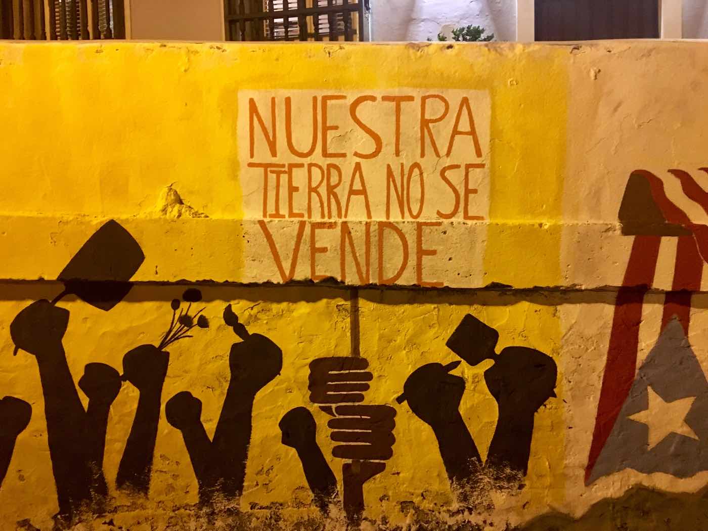 A mural in Puerto Rico reading “Our land is not for sale.”