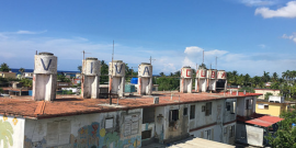 Habana rooftops with water tanks that have "Viva Cuba" painted on them