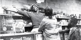 Woman standing behind the counter of a cooperative market.