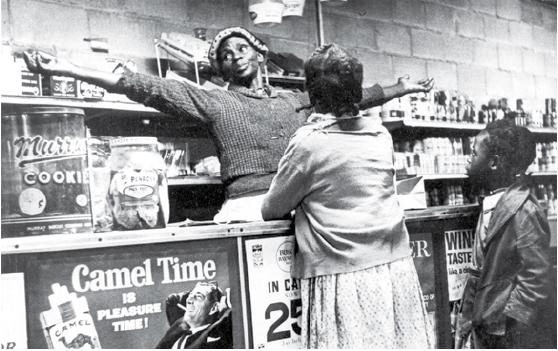 Woman standing behind the counter of a cooperative market.