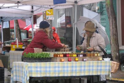 Huddling against the cold at the Growing Things Farm stall at the Ballard Farmers' Market