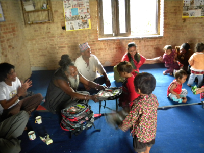 Kali Baba distributes school supplies to the first class of students.