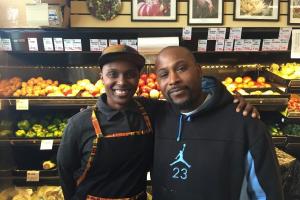 Adrionna Fike and James Bell, two of the worker-owners at Mandela Foods, in front of their revamped produce cooler.