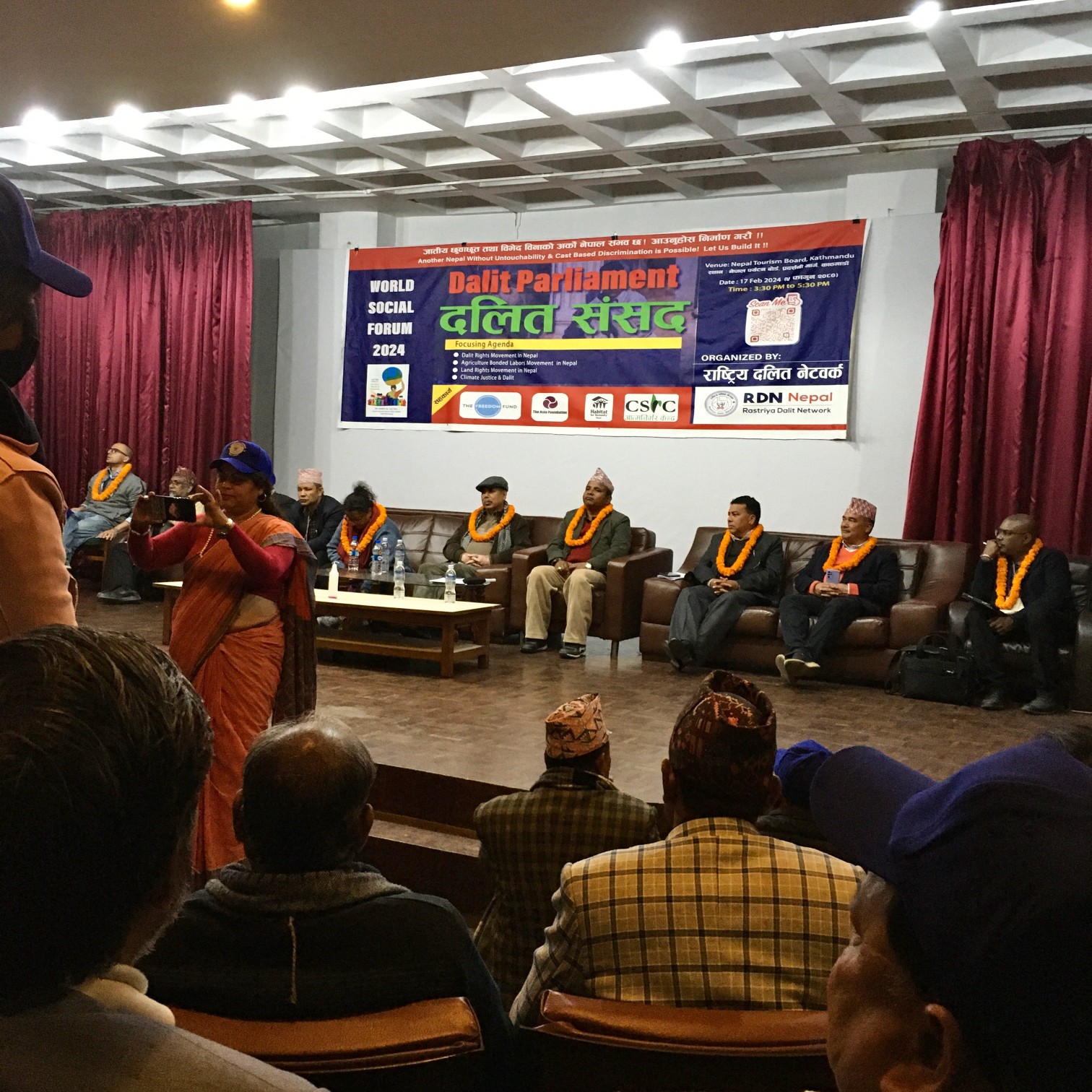 Honoured delegates taking their seats in the Parliament session.