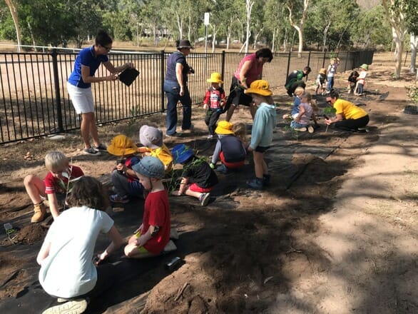 Children plant trees.