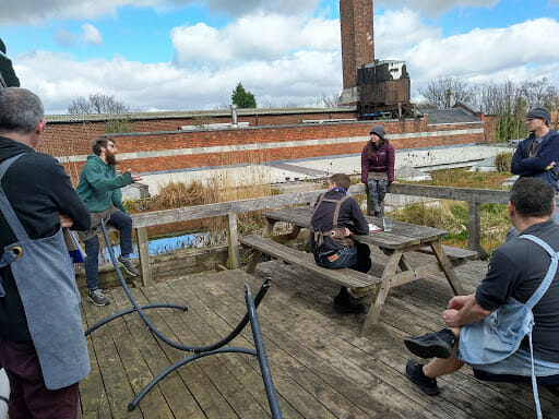 Six Unicorn Grocery worker-owners having on conversation on a patio.